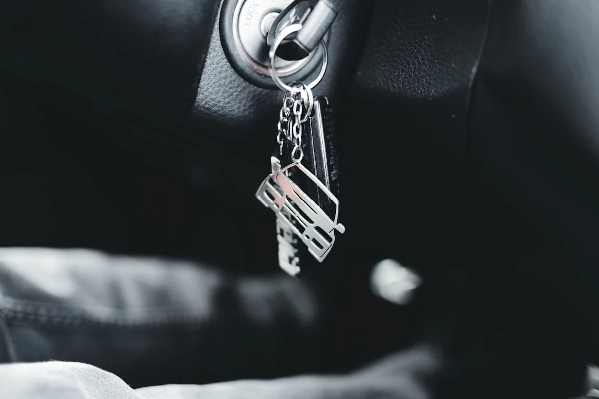 A car key held in a hand, close up.